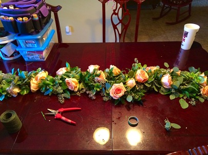 Garland with greens, caramel roses, and white veronica