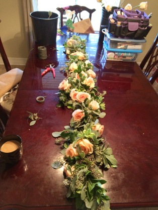 Garland with greens, caramel roses and white veronica